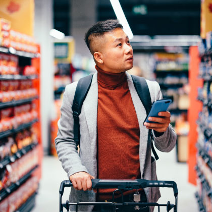 Man pushing shopping cart shopping